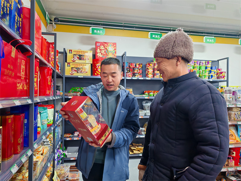圖為王金勇（左）為零售客戶介紹商品特點(diǎn)