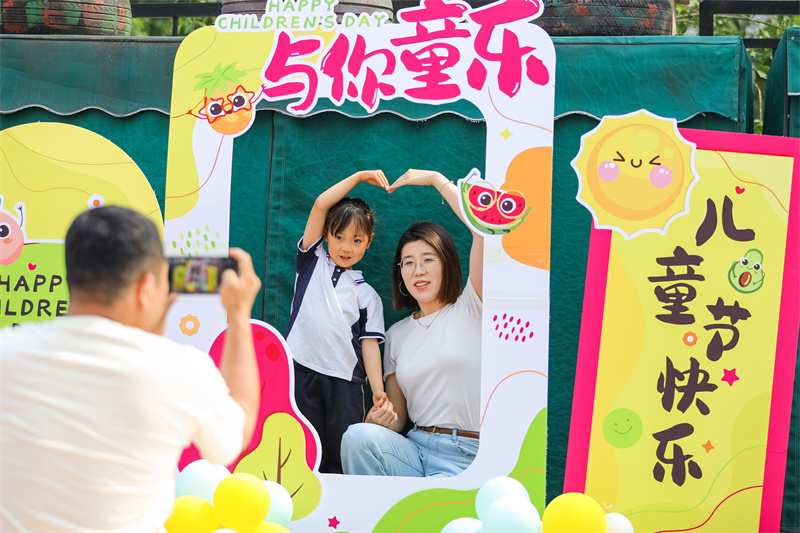 2025年5月26日，在山東省青島市李滄區(qū)青山路幼兒園開展迎“六一”主題活動中，小朋友和家長一起拍照打卡。張鷹 攝
